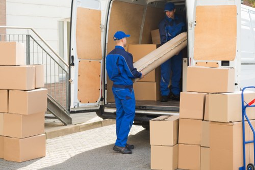 Man with van loading furniture for a Canonbury removal
