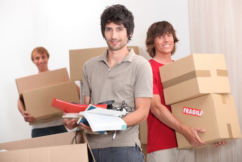 Movers carrying furniture through a residential Canonbury property