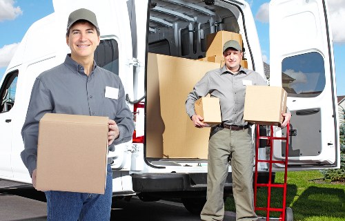 Loading boxes and household items into a moving van in Canonbury